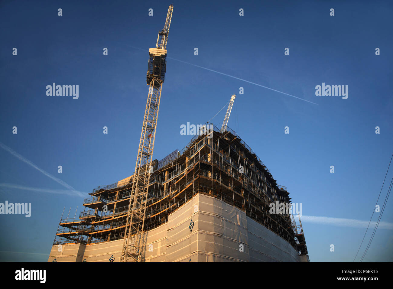 High rise crane seen here working construction building site in Leeds, Yorkshire Stock Photo Alamy