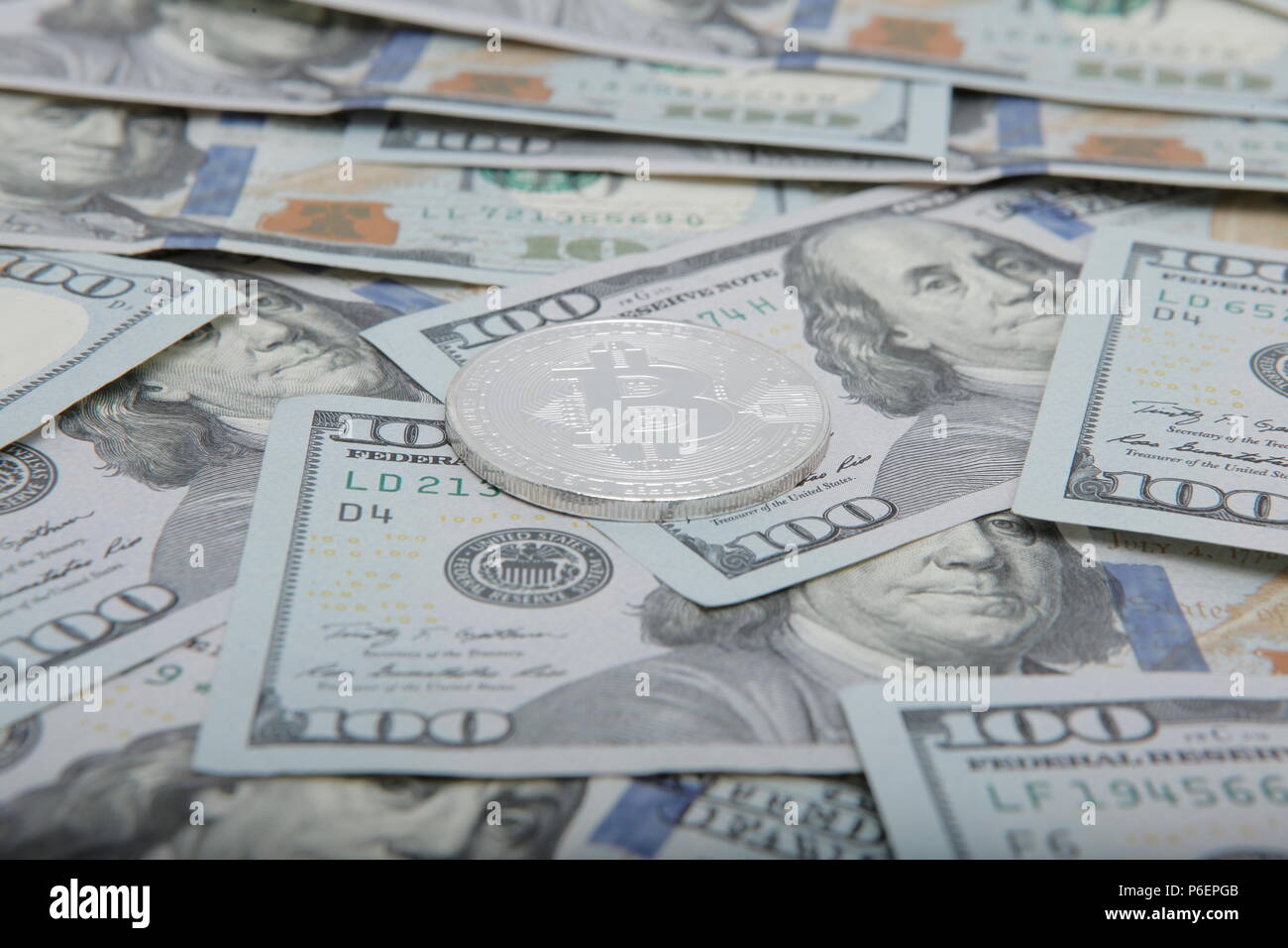 coins of the bitcoin against the background of dollar notes. bitcoin the  most Popular cryptocurrency in the world Stock Photo - Alamy