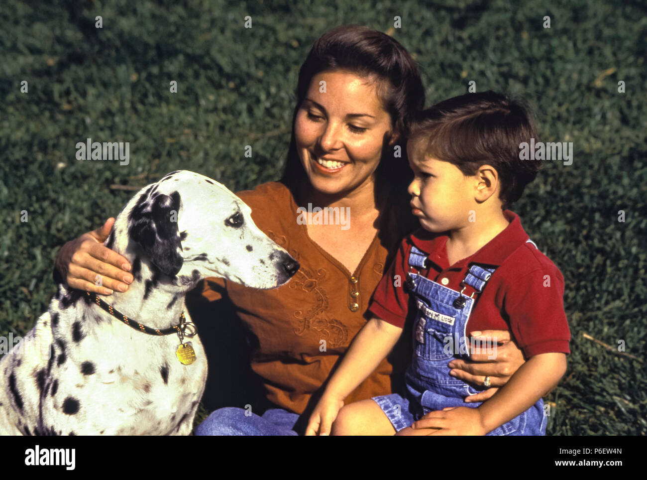 Mom introduces Fearful little boy meeting dog for first time. MR   © Myrleen Pearson. Ferguson Cate Stock Photo
