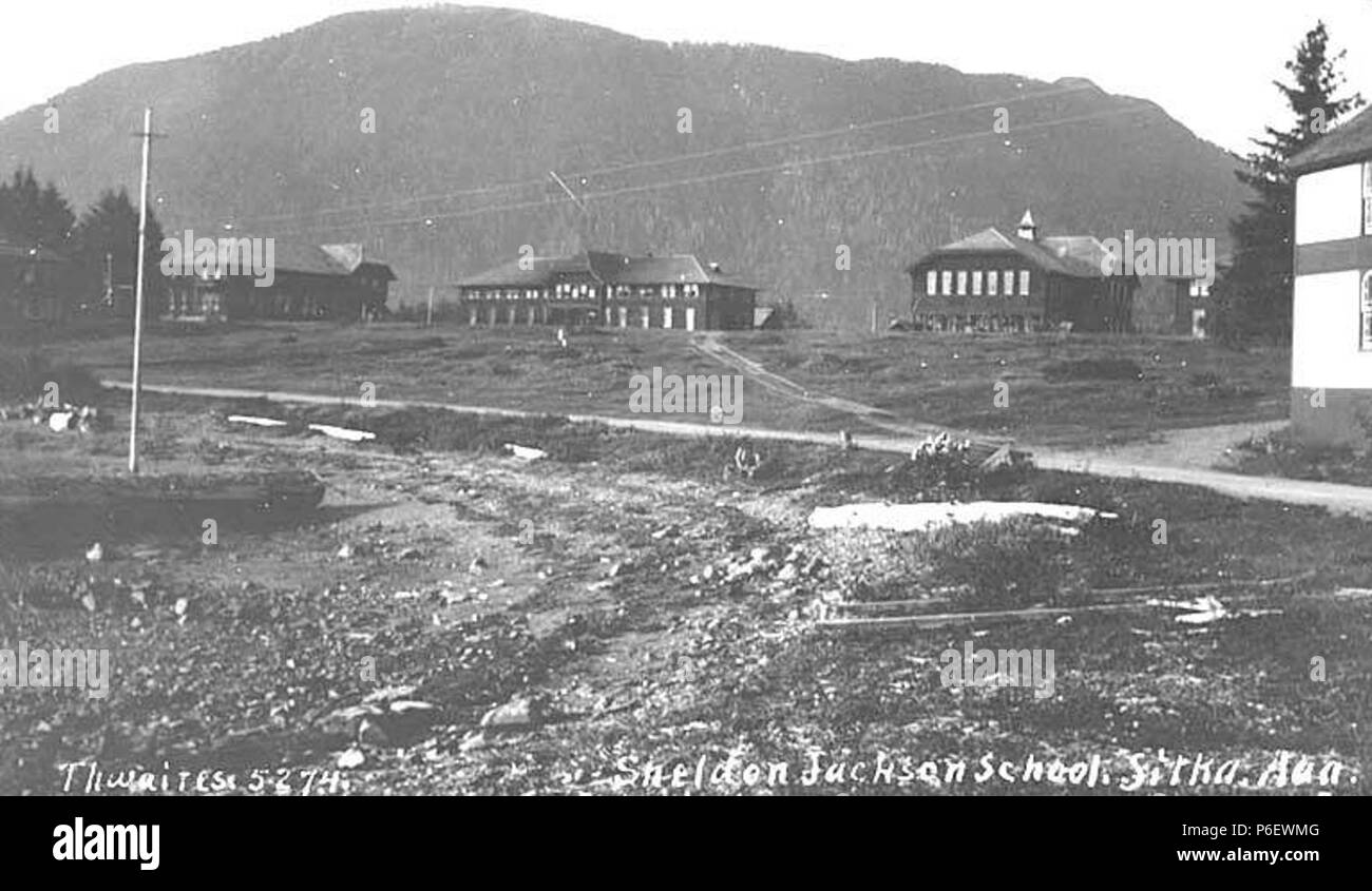 . English: Buildings of the Sheldon Jackson School, Sitka, ca. 1914 . English: Caption on image: Sheldon Jackson School, Sitka, Alaska PH Coll 247.692 Sheldon Jackson College is the oldest educational institution in continuous existence in the State of Alaska. It had its beginning in 1878 when Presbyterian missionaries John G. Brady (later Governor of Alaska) and Fannie Kellogg opened the upper floor of an old military barracks as a training school for Tlingit Indians. In 1882, the building burned to the ground. Another Presbyterian missionary, Dr. Sheldon Jackson, came to the rescue. He initi Stock Photo