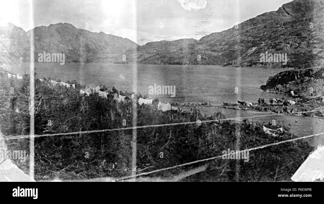 . English: Camp at Long Lake, Chilkoot Trail, British Columbia, September 18, 1897 . English: On verso of image: Long Lake looking north, Sept. 18, 1897 . PH Coll 35.456 Subjects (LCTGM): Lakes--British Columbia; Tents--British Columbia; Trails & paths--British Columbia Subjects (LCSH): Long Lake (B.C.); Chilkoot Trail  . 1897 9 Camp at Long Lake, Chilkoot Trail, British Columbia, September 18, 1897 (SARVANT 210) Stock Photo
