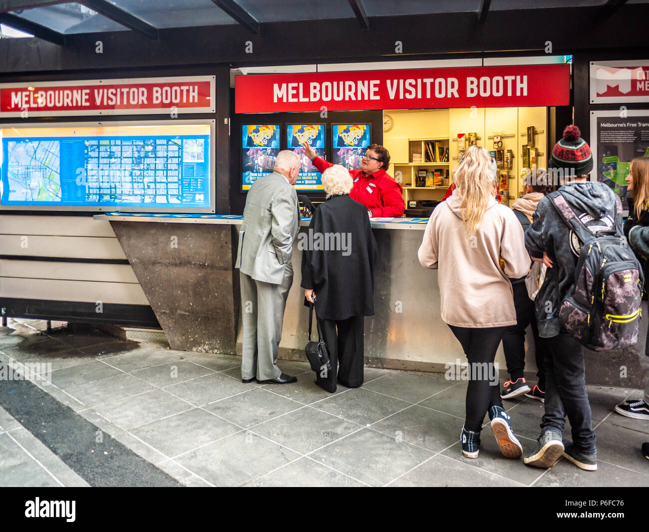 Staff helping tourists at Melbourne Visitor Booth. The booth is staffed by trained volunteers and conveniently located in the Bourke Street Mall. Stock Photo