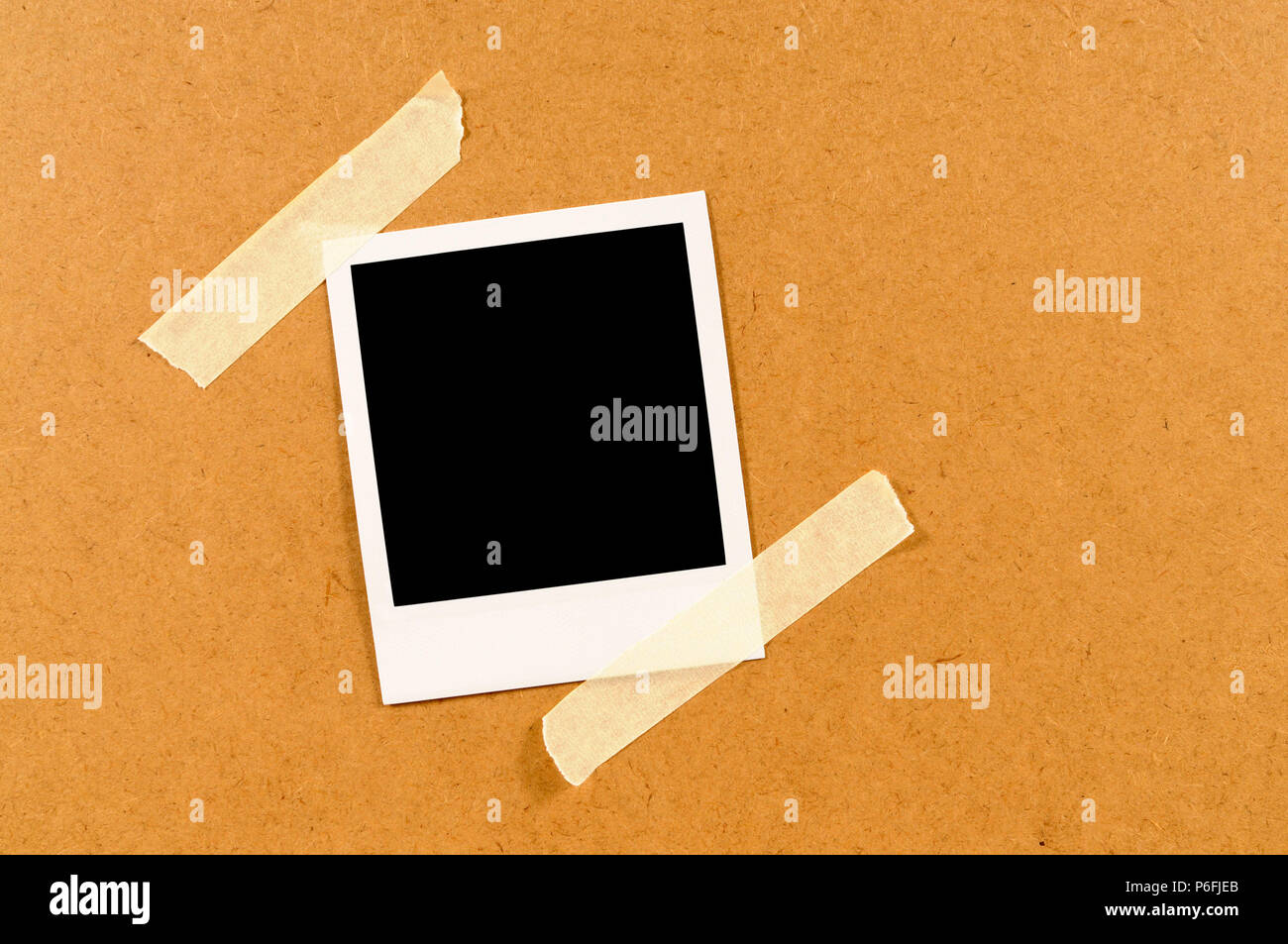 Blank instant photo print sticky taped to a wooden board Stock Photo