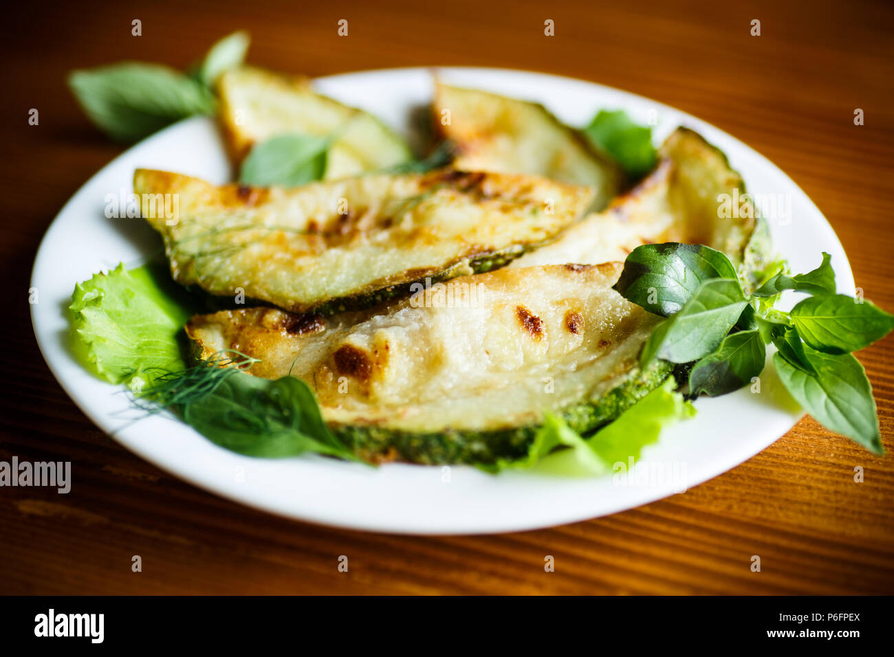 fried zucchini seasoned with dill Stock Photo Alamy