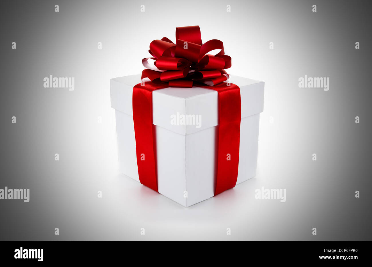 White gift box with red ribbon and bow on grey background Stock Photo ...