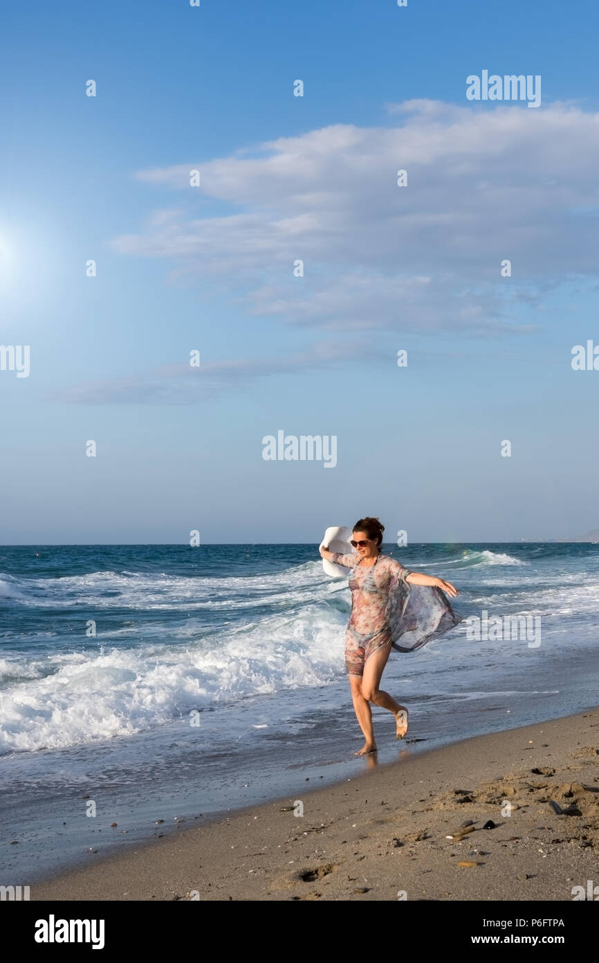 Adult woman enjoying the summer beach Stock Photo