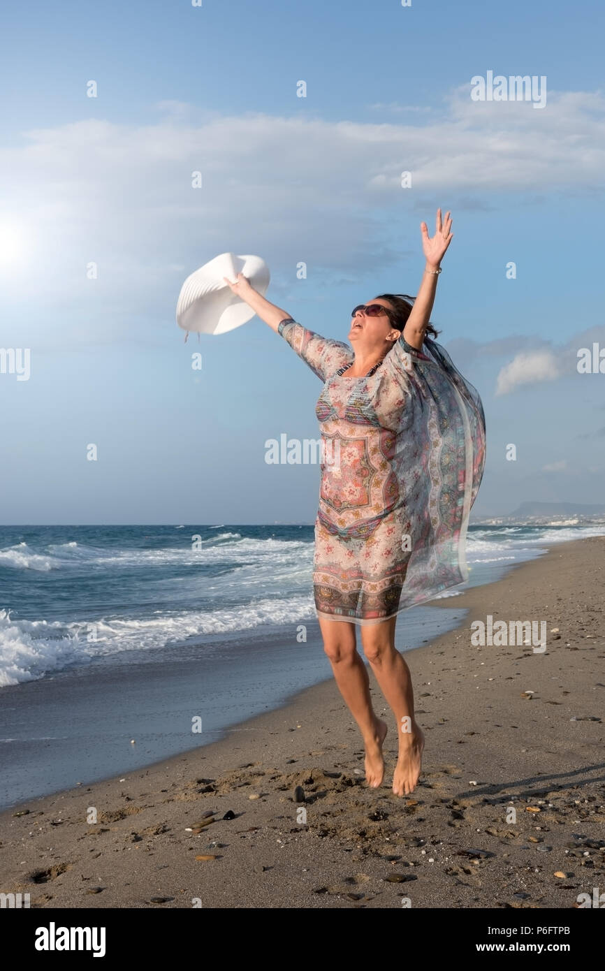 Energetic woman enjoying summer on the beach Stock Photo