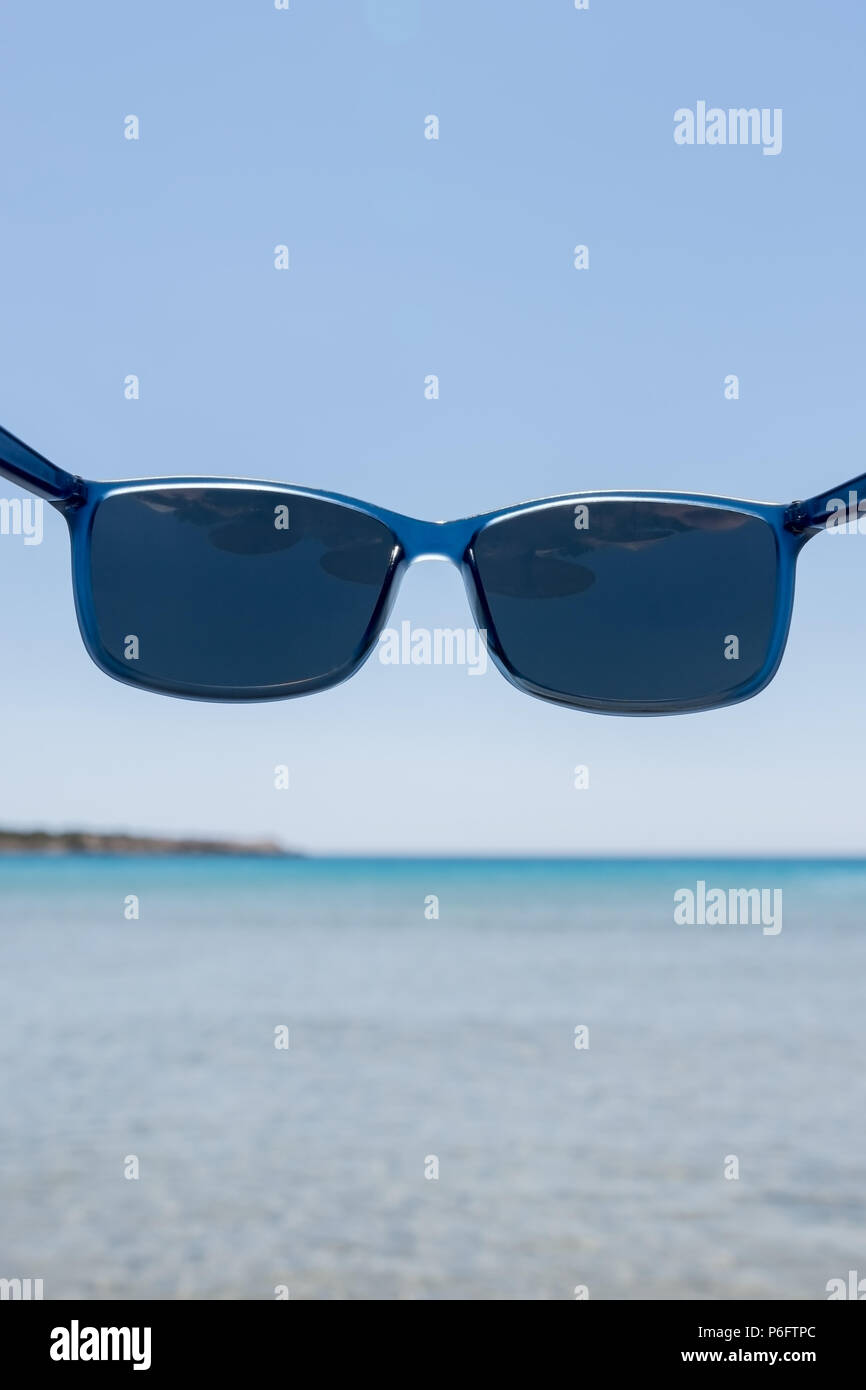 Blue sunglasses with polarized lenses that protect your eyes from bright sea light Stock Photo