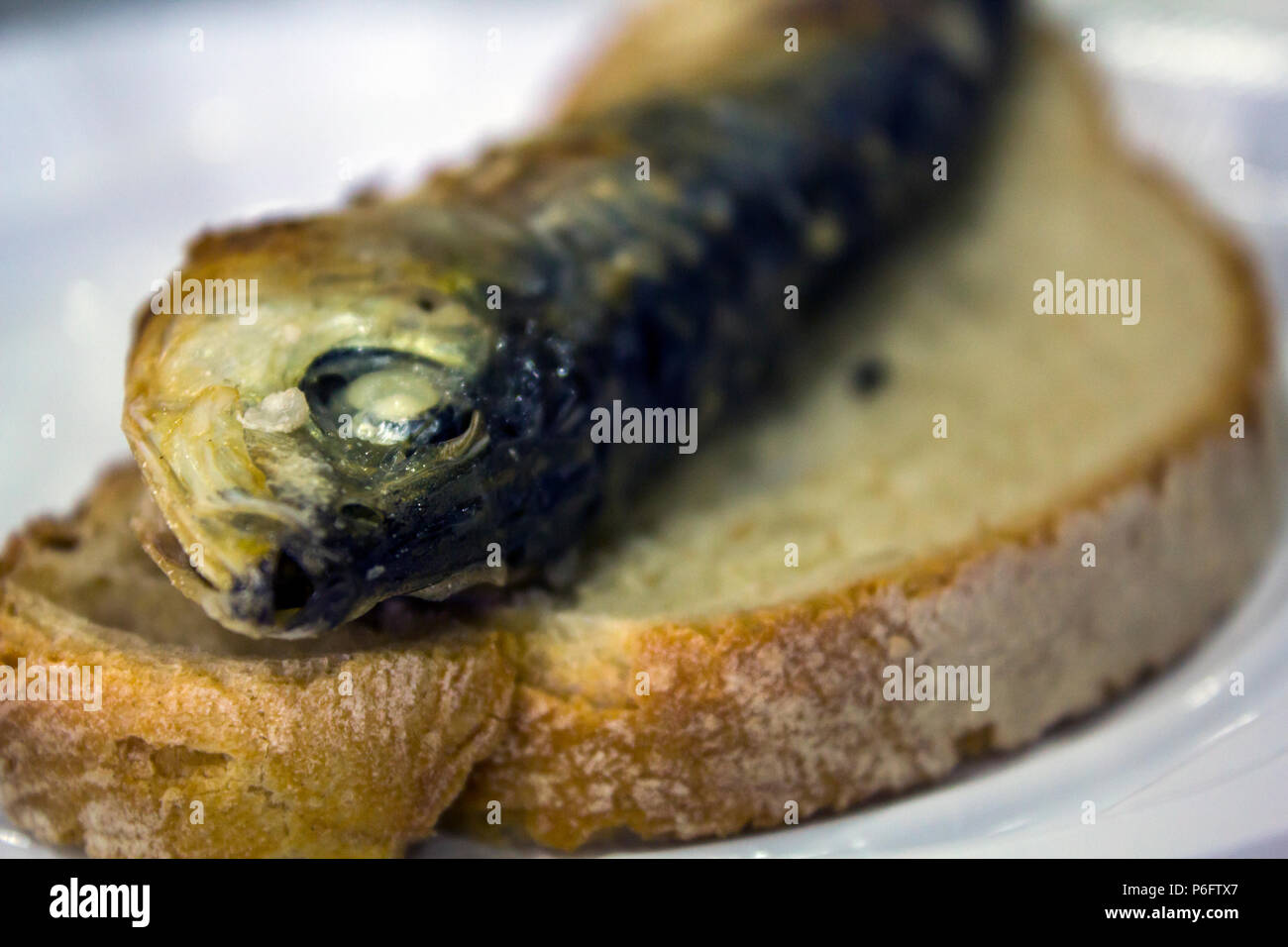Grilled sardine on a piece of bread Stock Photo Alamy