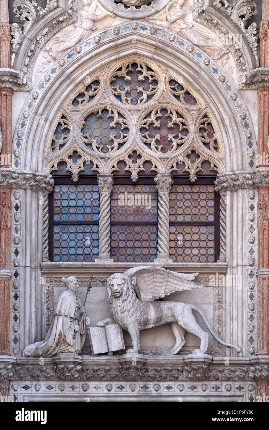 Detail of the Porta della Carta entrance to the Doge's Palace in Venice, Italy, depicting Doge Francesco Foscari kneeling before the Lion of St. Mark Stock Photo