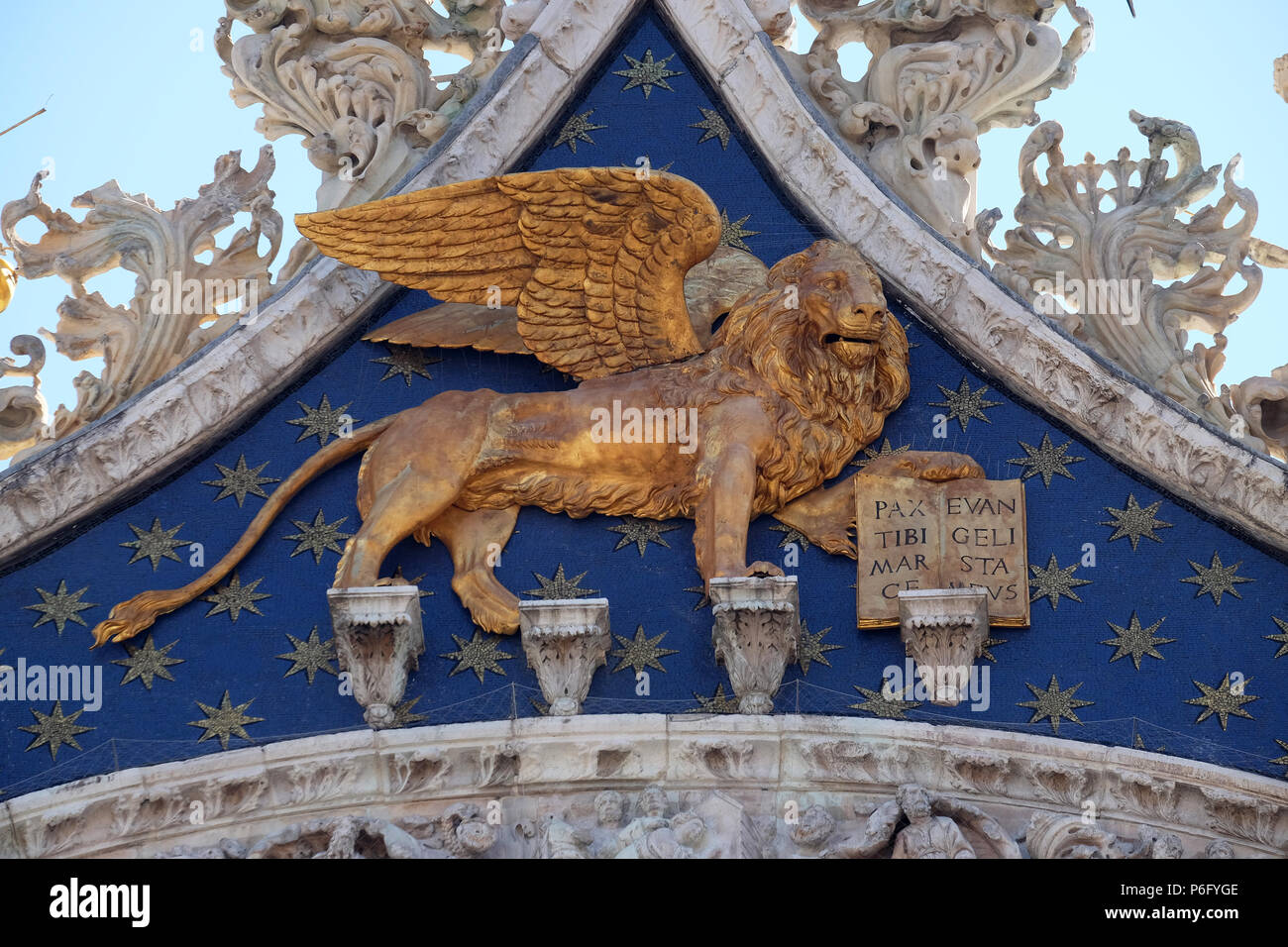 Statue golden winged lion, symbol of Venice on the Basilica of St. Mark on Piazza San Marco, Venice, Italy Stock Photo