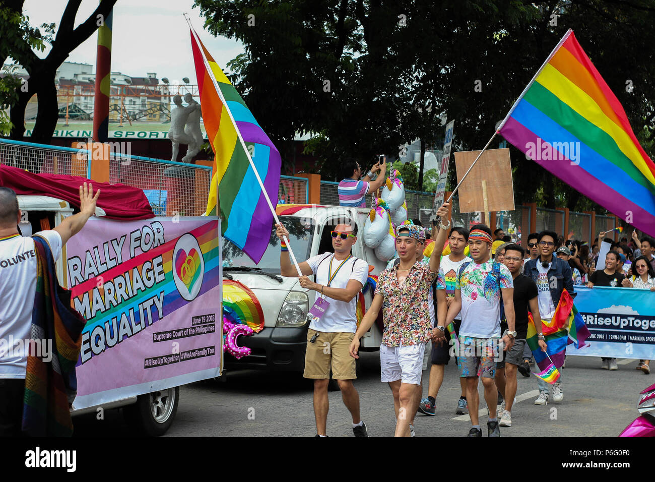 participants seen waiving the rainbow flags. Thousands gathered around