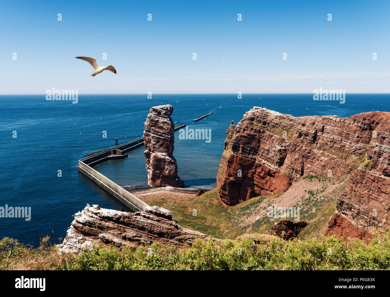 Lange Anna sea stack rock on Heligoland Island against blue sea and clear sky Stock Photo