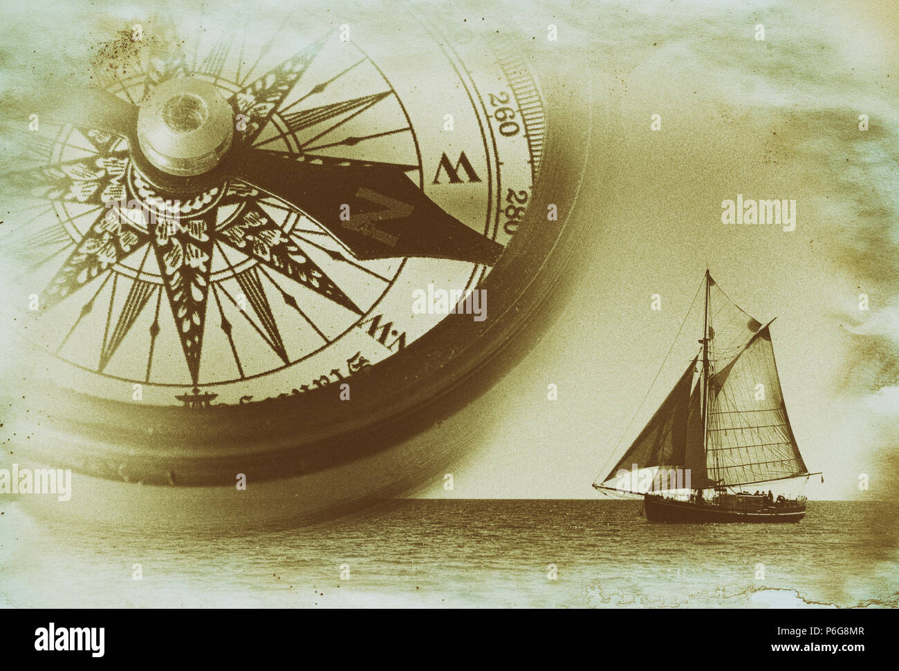 Gaff sail with compass on old made Stock Photo