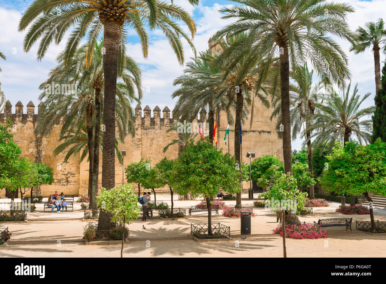 Cordoba Alcazar, view from the Calle Caballerizas Reales across the palm tree lined plaza in front of the Alcazar de Los Reyes Cristianos, Cordoba. Stock Photo