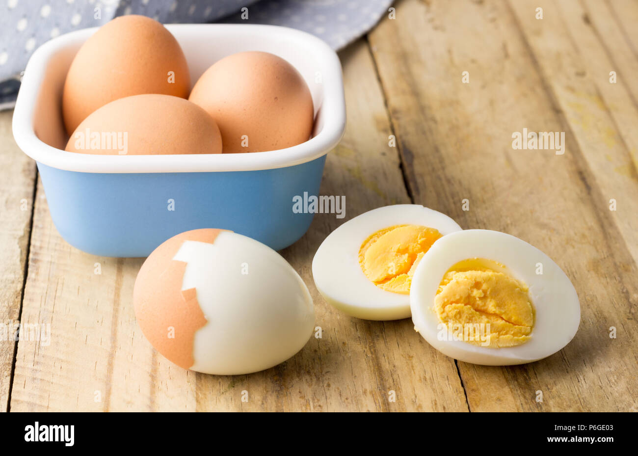 Hard boiled chicken eggs on rustic wooden table Stock Photo