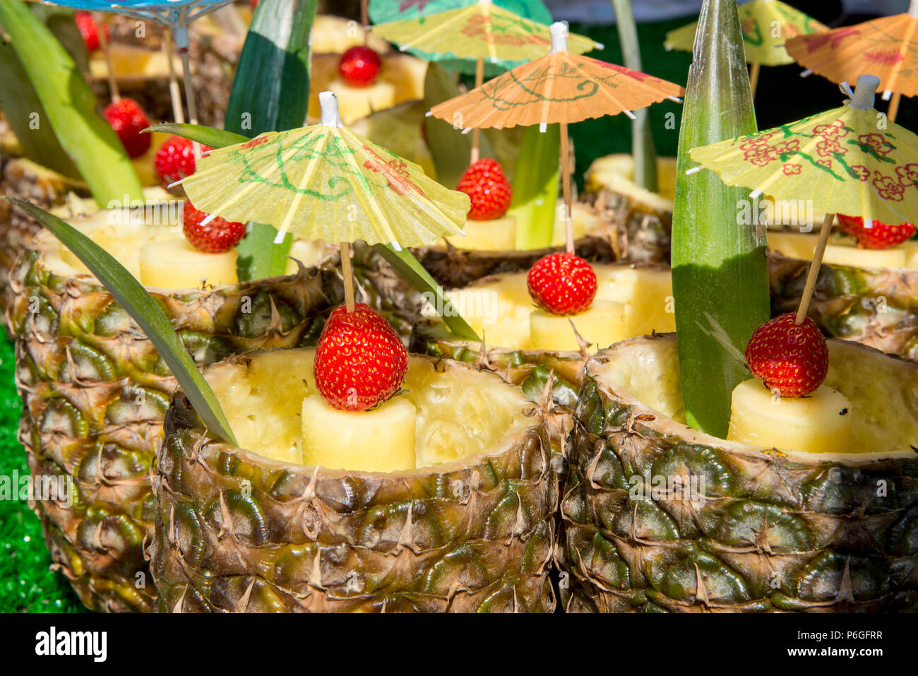Fresh Tropical Pina Colada cocktail served in a pineapple - Summer Food  Street Market Stock Photo - Alamy