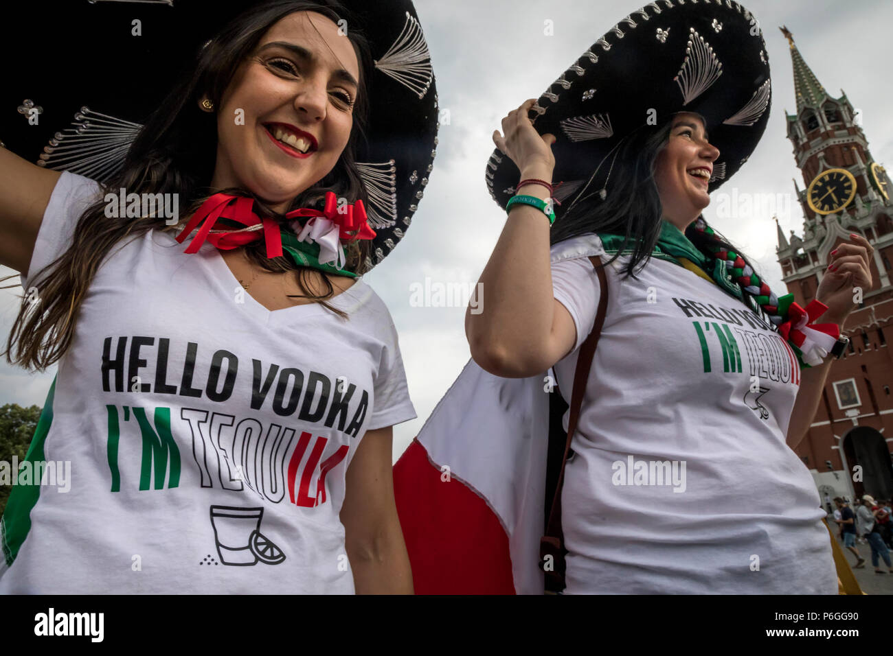 Mexican women in a sombrero with an inscription on T-shirts 'Hello vodka I am tequila' are walking along Red Square in Moscow during the World Cup Stock Photo
