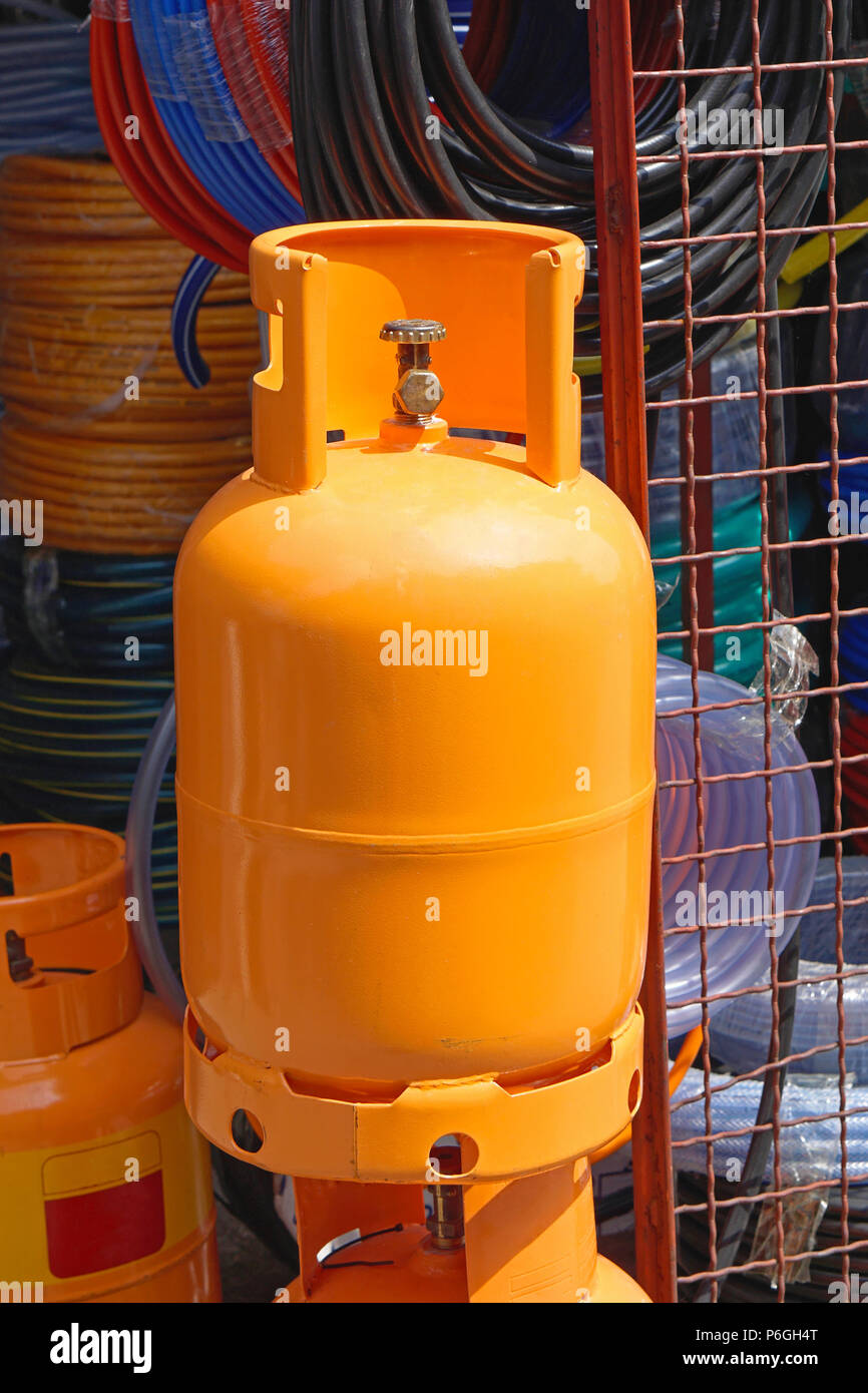 Orange gas cylinder for home use Stock Photo - Alamy