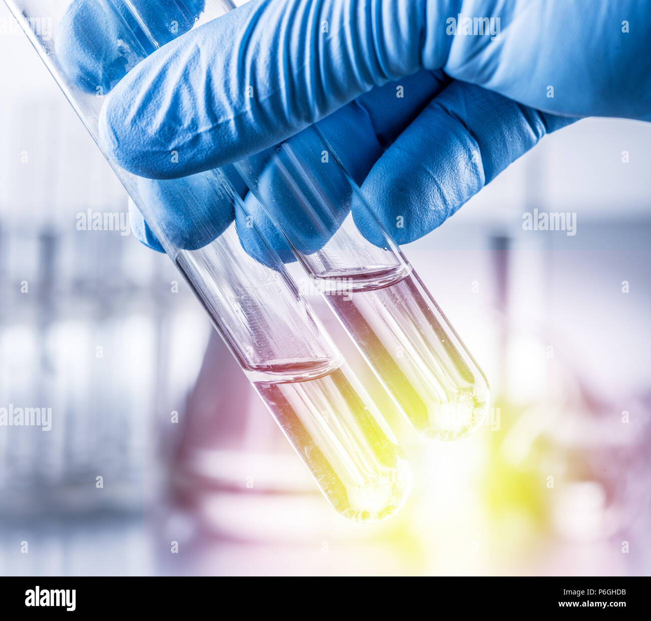 Laboratory beakers in analyst's hand in plastic glove Stock Photo Alamy