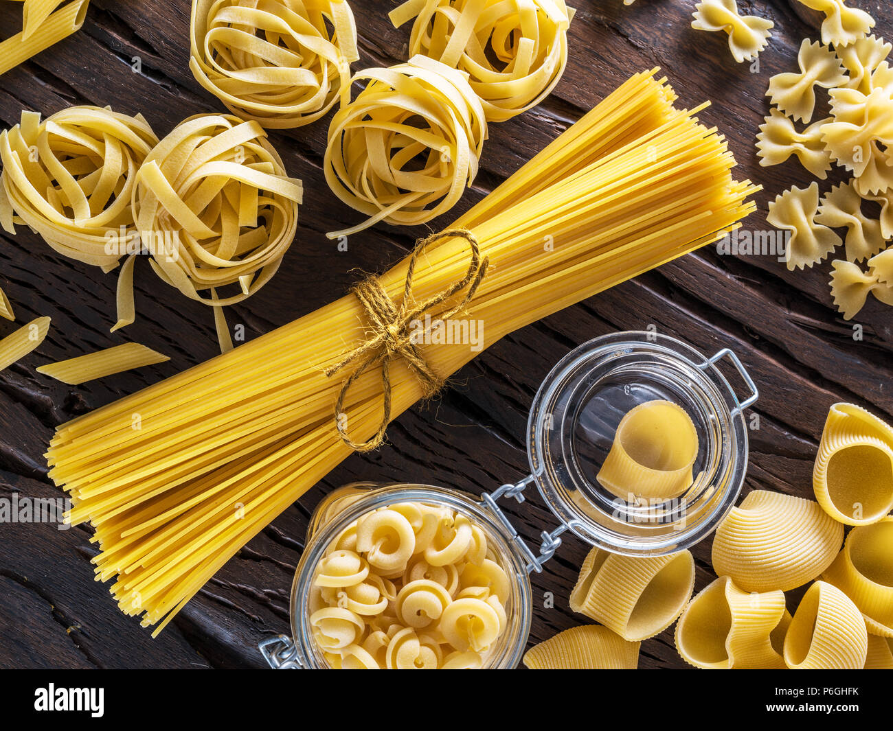 Different pasta types on the wooden table. Stock Photo