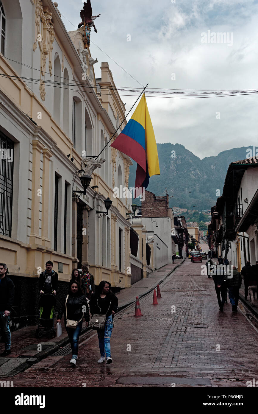 Street scene in central Bogota with national flag and mist covering the monserratte mountain behind, colombia Stock Photo