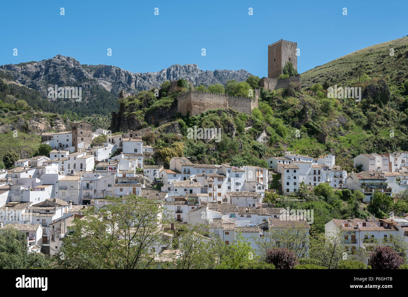 Picturesque town Cazorla with moorish fortress tower La Yerda and typical white houses surrounded by mountain range Sierra de Cazorla. Andalusia, Spai Stock Photo