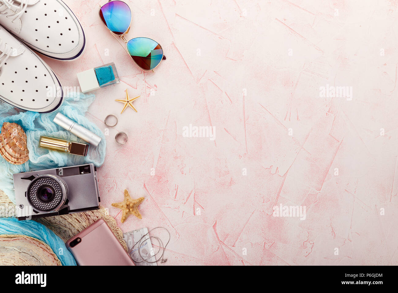 Outfit and accessories of traveler on pink background with copy space, Travel concept. Stock Photo