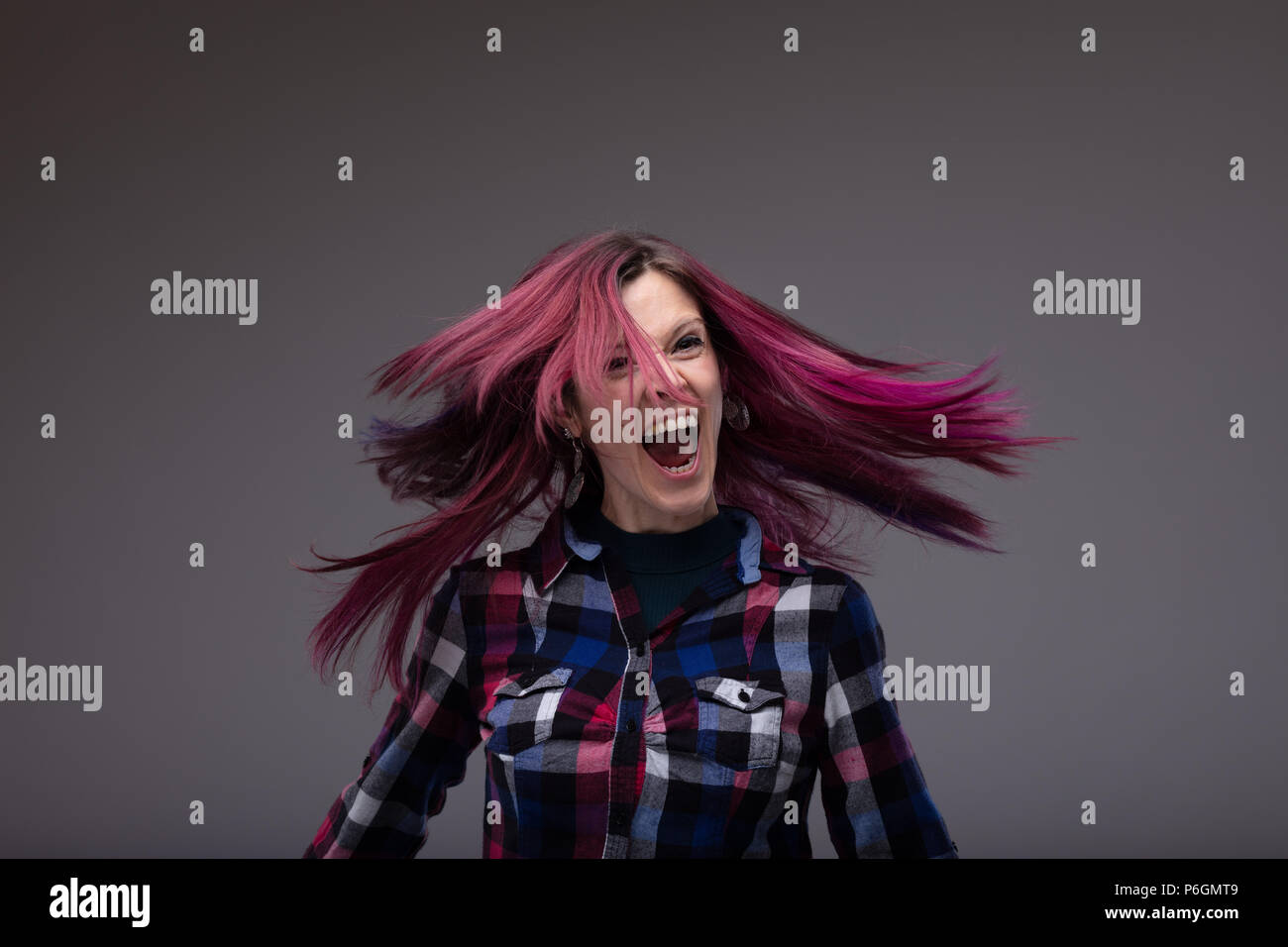 Happy Laughing Woman Flicking Her Purple Tinted Long Hair In The