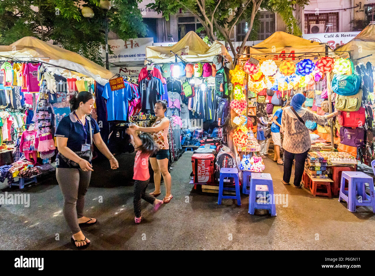 Vietnamese children playing in street near night market in Ho Chi Minh