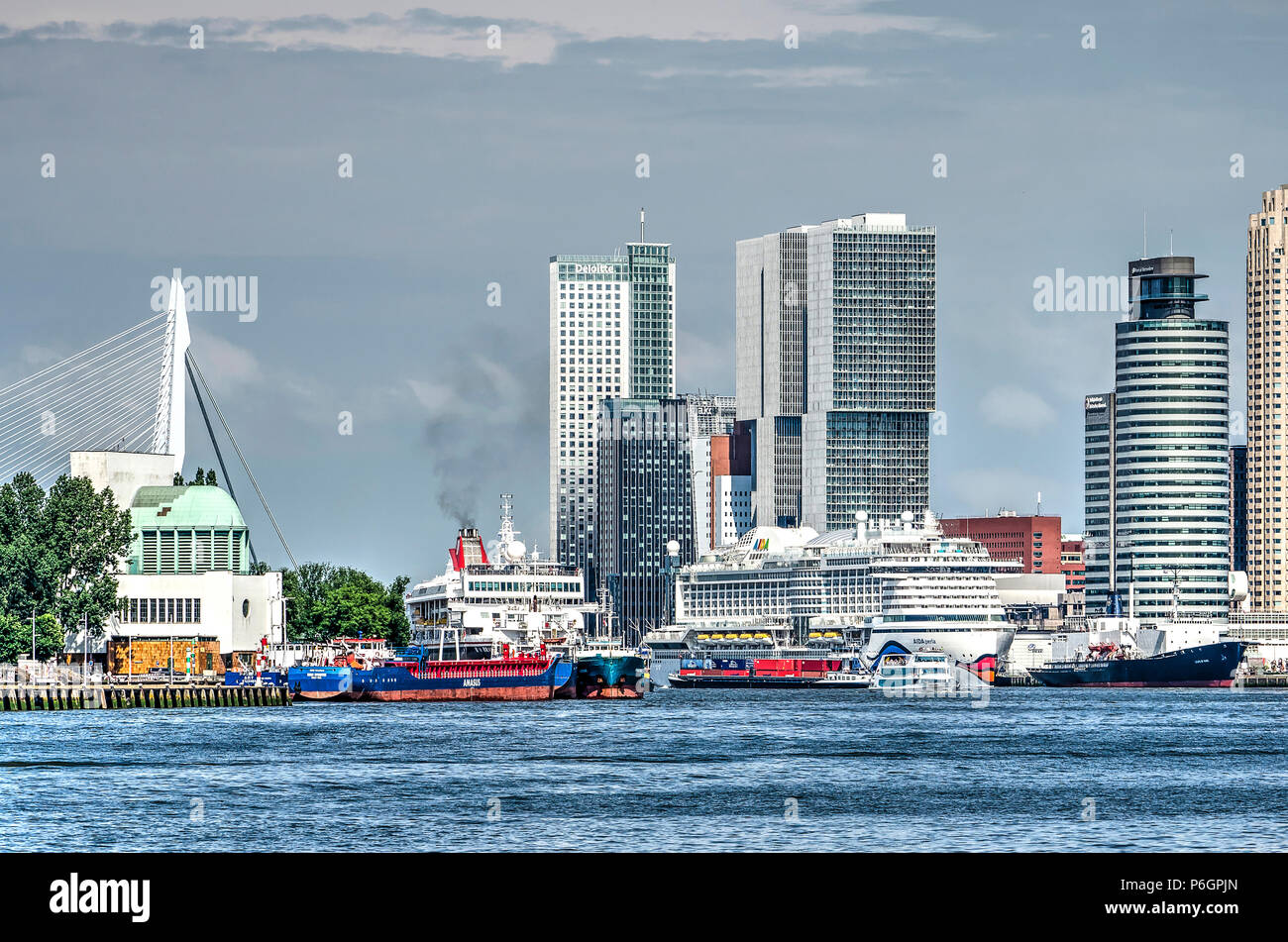 Rotterdam, The Netherlands, May 31, 2018: Cruiseships, cargo vessels and a tourist boat on the Nieuwe Maas river between downtown and the southbank Stock Photo