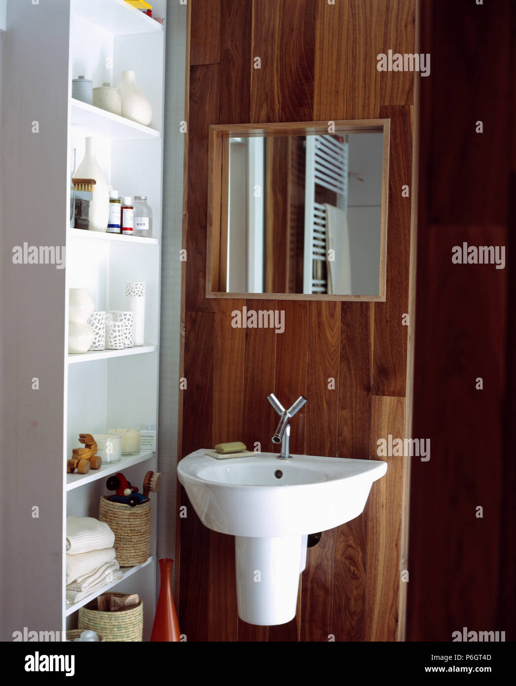 Wall-shelving beside mirror above basin in modern bathroom Stock Photo ...