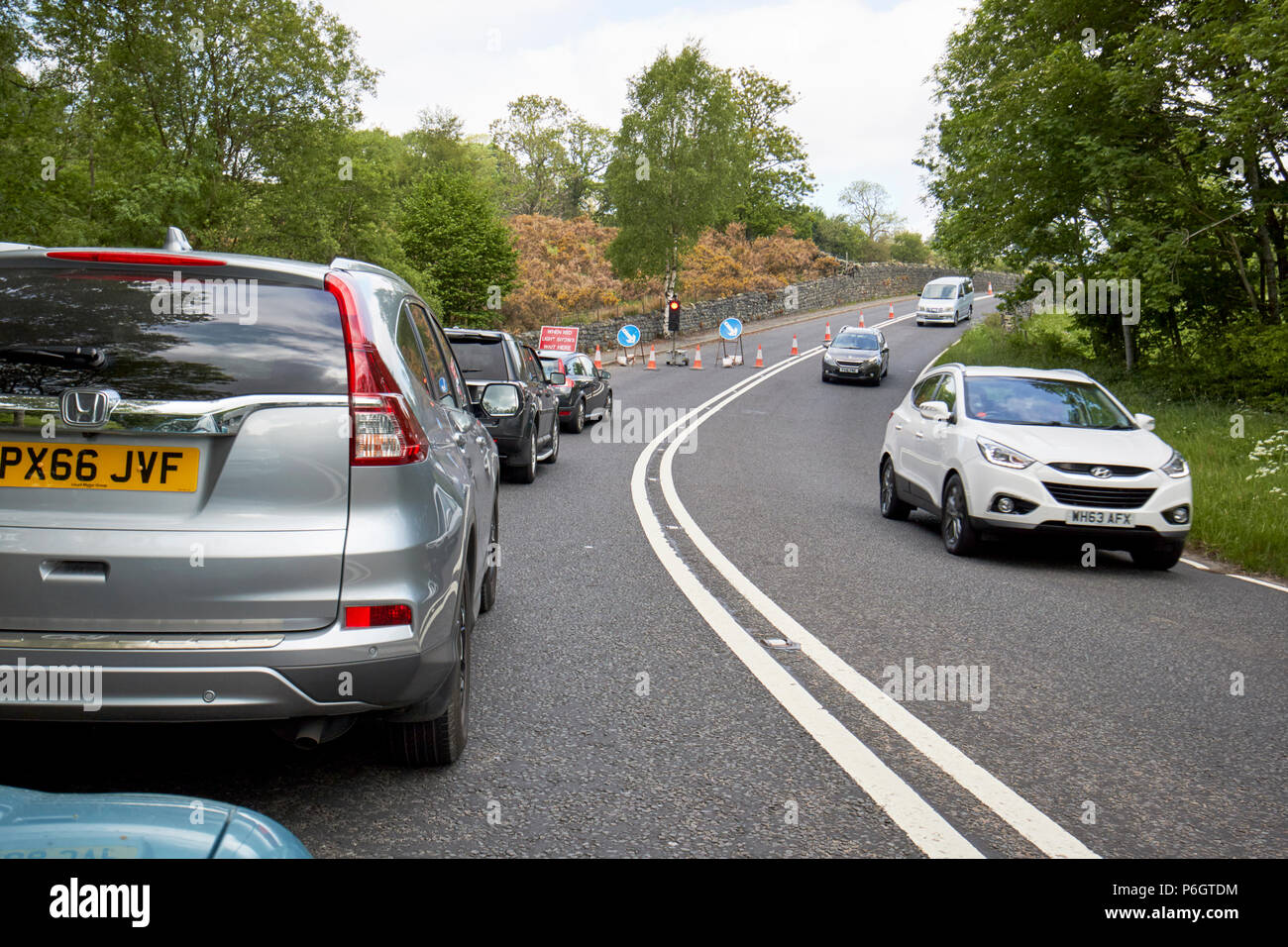 traffic in roadworks on a no overtaking section of the a591  near keswick in the lake district cumbria england uk Stock Photo