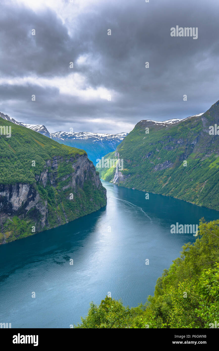 mystical mood at Geirangerfjord, Norway, fjord in evening light and cloudy sky, panorama view from Eagle View at Ornevegen road Stock Photo