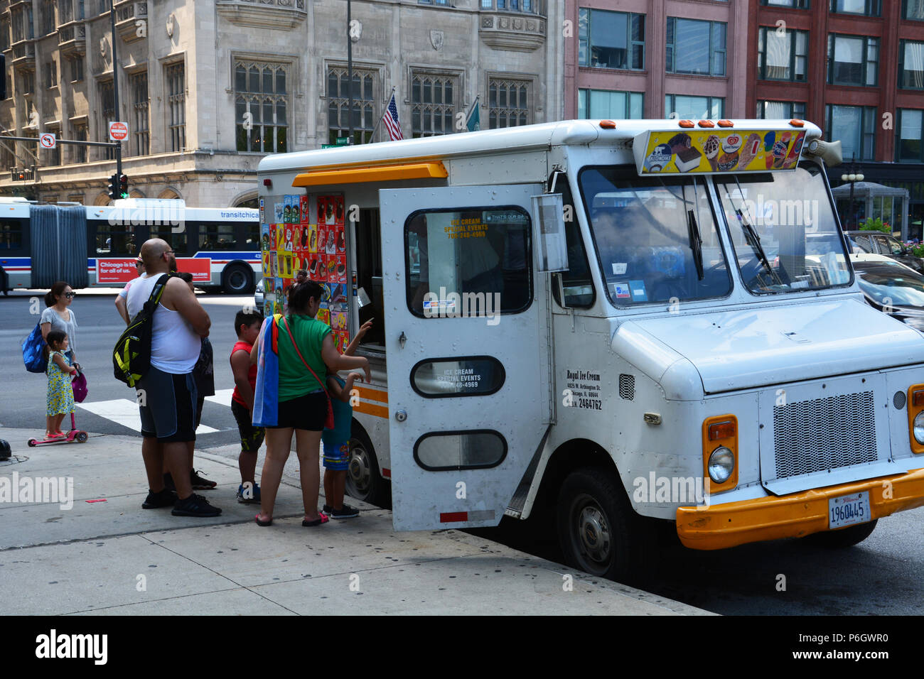 A family buys ice cream bars from a vintage truck next to Chicago's Millennium Park. Stock Photo