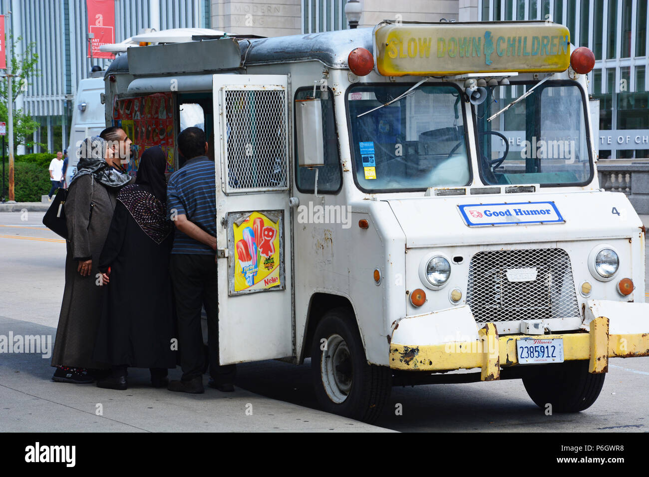 A family buys ice cream bars from a vintage Good Humor truck next to Chicago's Millennium Park. Stock Photo