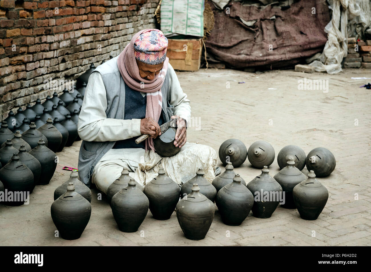Nepalese Potter making clay pots, Potters Square, Bhaktapur, Nepal Stock Photo