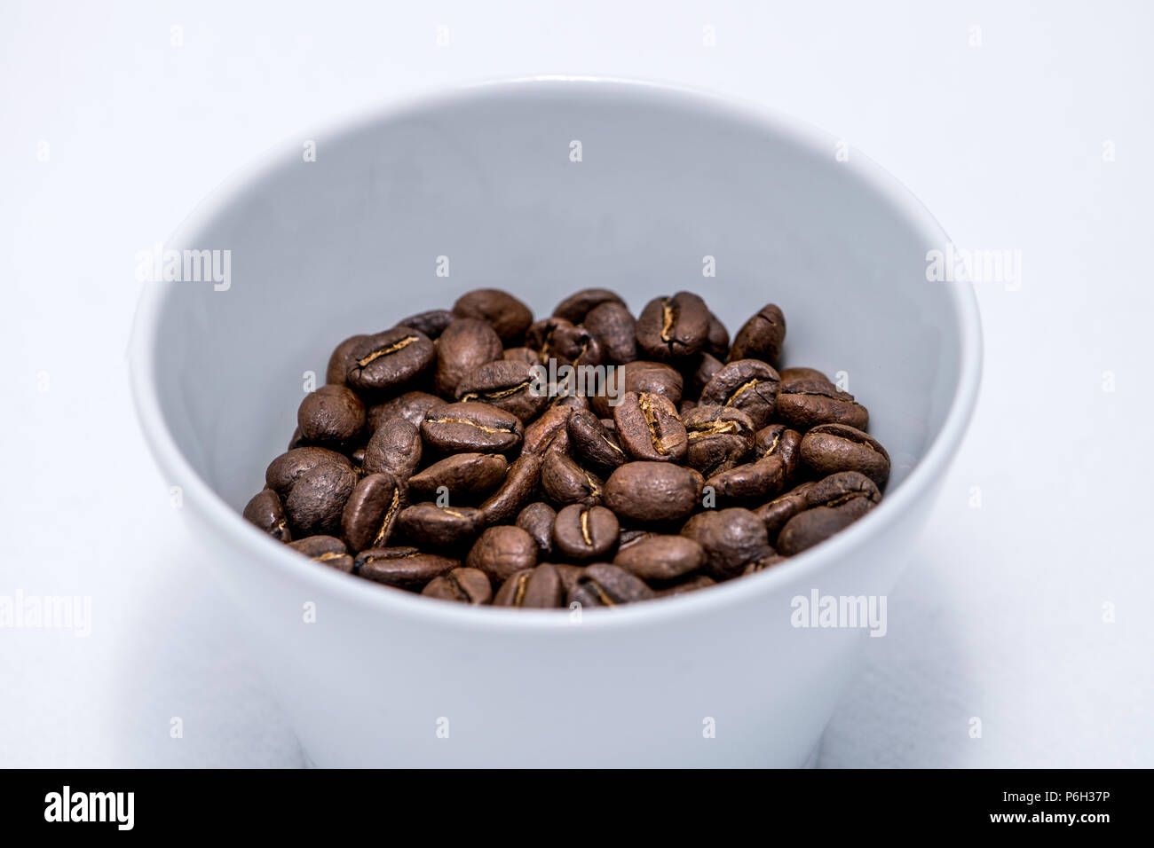 Coffee beans isolated on a white background in a white cup Stock Photo ...