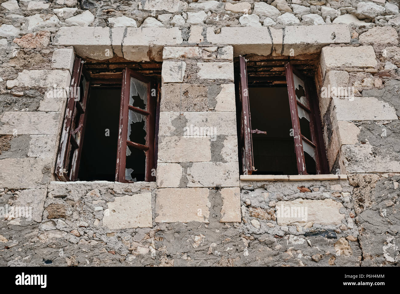 Broken windows with bars of an abandoned house Stock Photo - Alamy