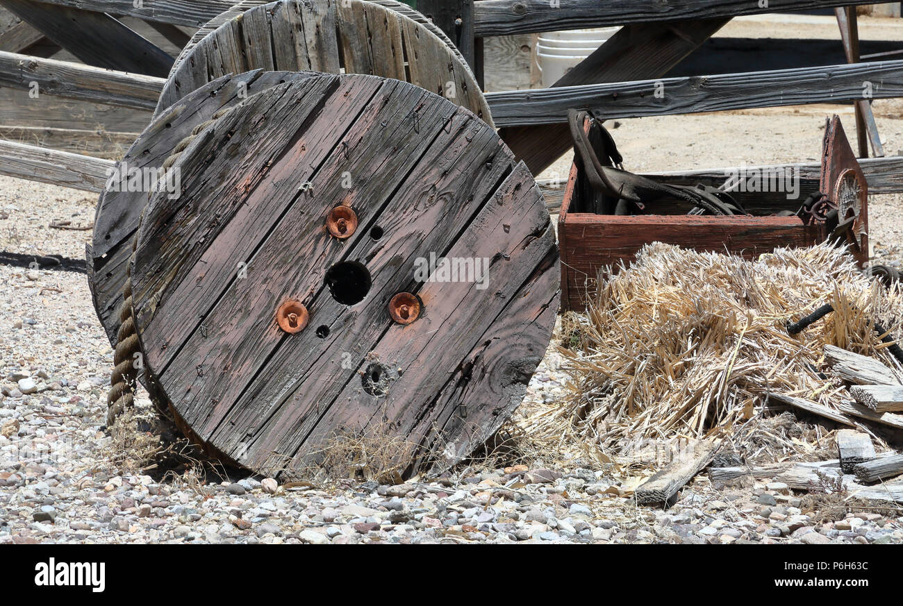 Large wooden spool with heavy rope and a broken toolbox on front of a ...