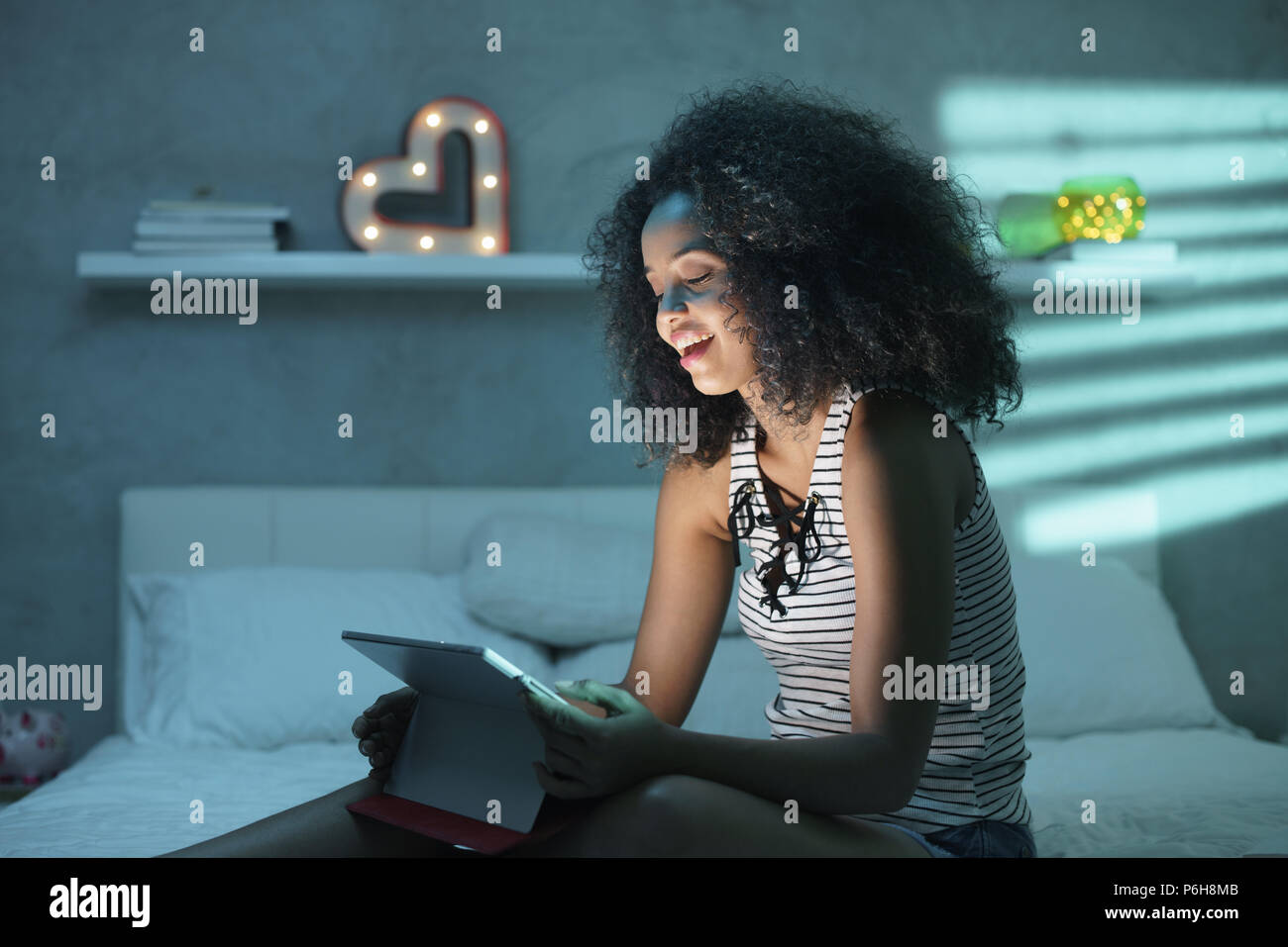 Young Black Woman Watching Movie With Laptop At Night Stock Photo