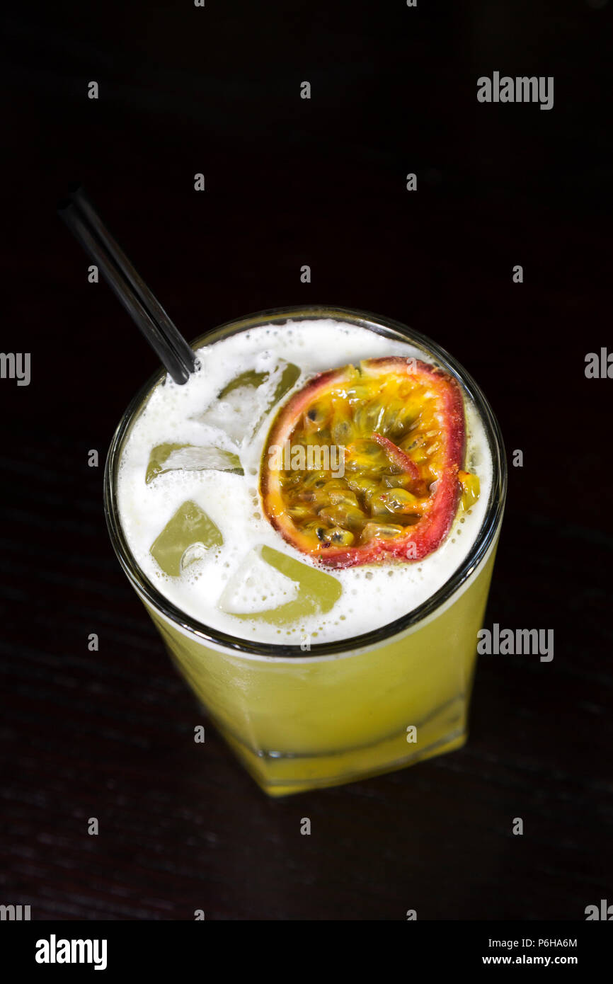 A rum-based cocktail with ice. The drink features passion fruit. Stock Photo