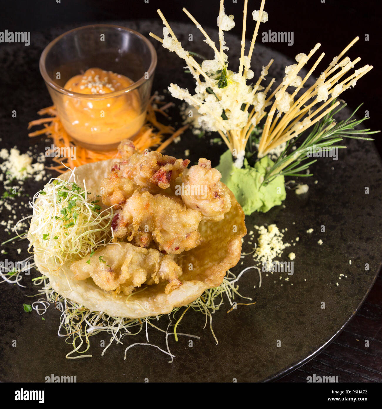 Lobster tempura with Sriracha mayo. The deep fried dish has Asian influences. Stock Photo