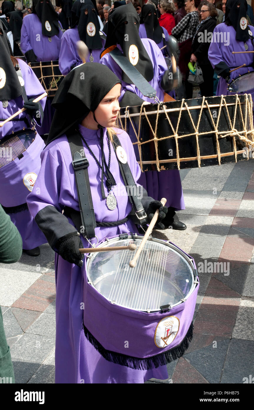Girl playing the drum during a Holy Week procession. Madrid, Spain. Stock Photo