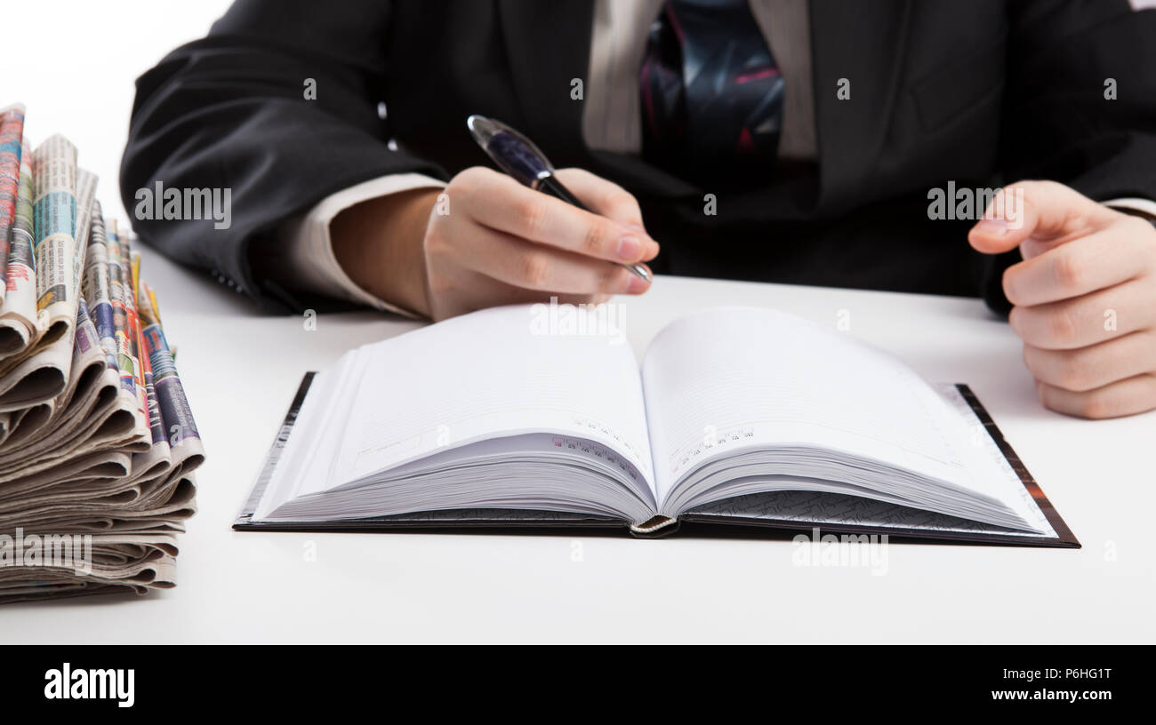 diary and human hand holding a pen close-up Stock Photo - Alamy