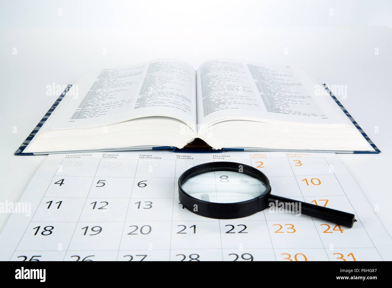 business still life consisting of sheet of a calendar, loupe