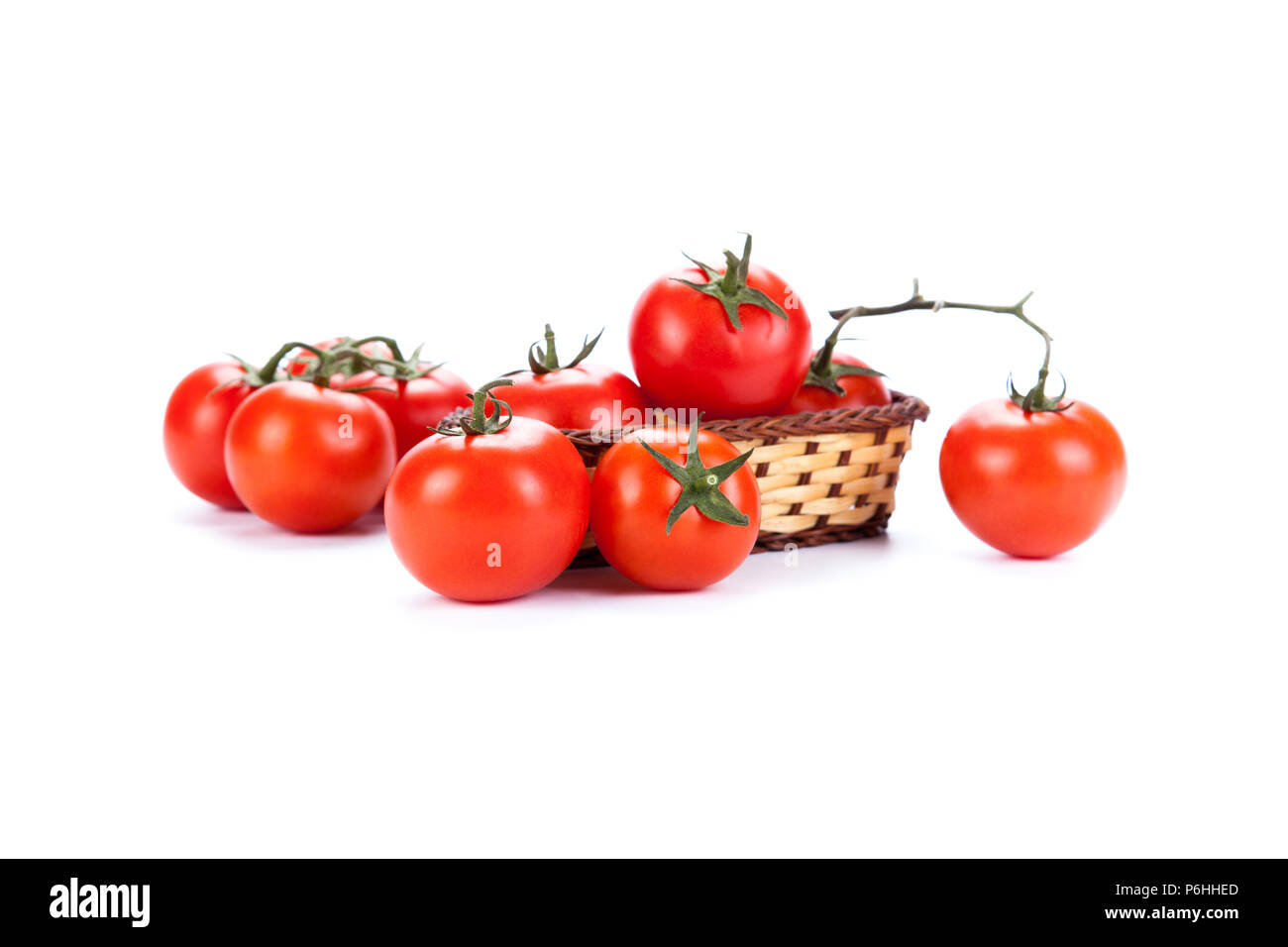 some red tomatoes in a small basket on a white background Stock Photo ...
