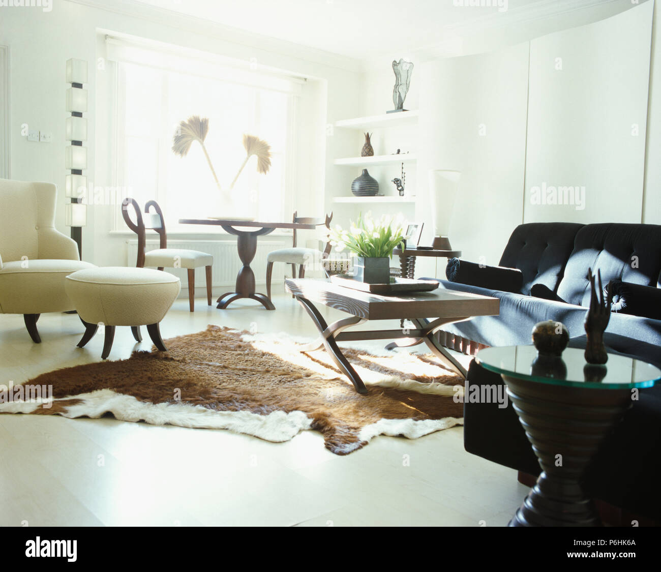 Cow Hide Rug On White Floor Of Modern Living And Dining Room Stock