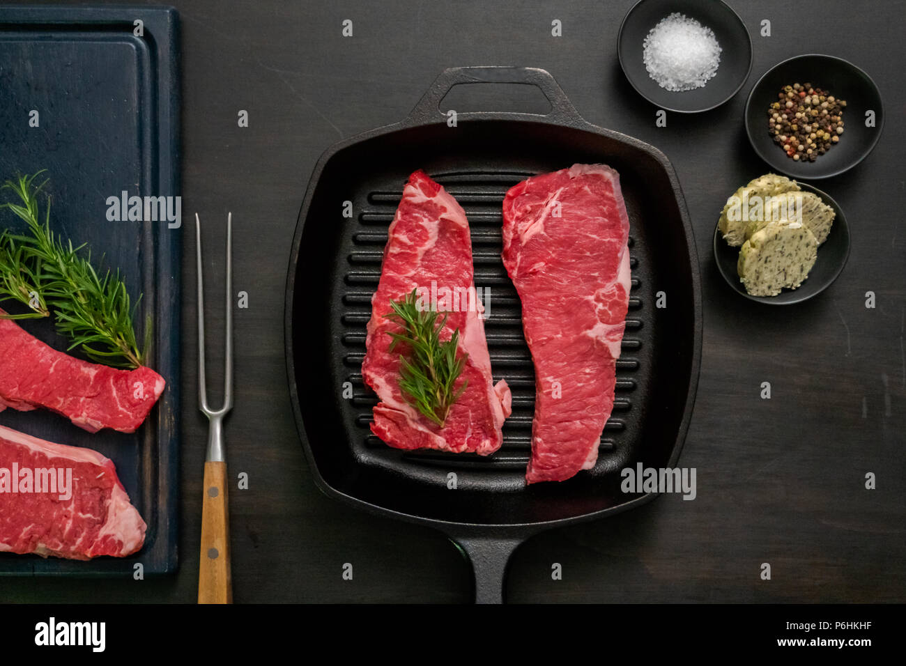 Raw New York strip steaks in cast iron frying pan Stock Photo Alamy