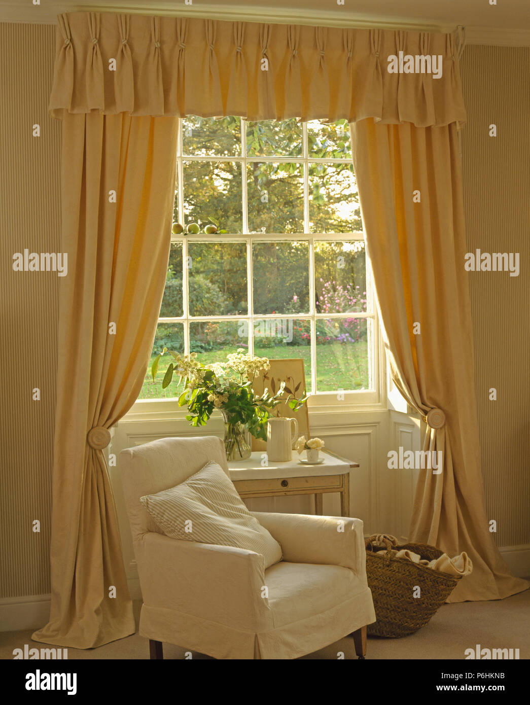 Armchair With Cream Loose Cover Beside Window With Long Cream